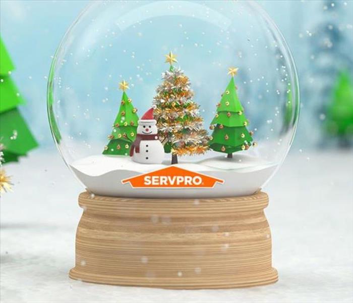 A snow globe is shown with the orange SERVPRO logo